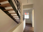Flur mit Treppe - Modernes Reihenendhaus – 4 Zimmer mit Garten, Wärmepumpe und zwei Stellplätzen